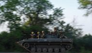 Ukrainian soldiers ride on a BMP infantry fighting vehicle toward Bakhmut, on May 20, 2023, amid the Russian invasion of Ukraine.  Photo by Sergey SHESTAK / AFP
