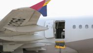 An opened door of an Asiana Airlines plane is seen at Daegu International Airport in Daegu on May 26, 2023, after it was manually opened by a passenger. (Photo by Yonhap/ AFP) 