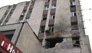 A local resident examines a partially destroyed residential building after a massive Russian drones strike mainly targetting the Ukrainian capital, in Kyiv, on May 28, 2023. (Photo by Sergei Supinsky / AFP)