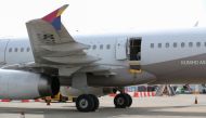 An opened door of an Asiana Airlines plane is seen at Daegu International Airport in Daegu on May 26, 2023, after it was manually opened by a passenger just 200 metres above the ground before landing causing some to have breathing difficulty but with no major injuries.
