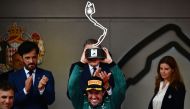 Second-placed Aston Martin's Spanish driver Fernando Alonso holds up his trophy on the podium after the Formula One Monaco Grand Prix at the Monaco street circuit in Monaco, on May 28, 2023. Photo by Jeff PACHOUD / AFP