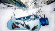 A photo taken on December 8, 2022, in Vaasa, shows plastic pieces in frozen water. Photo by Olivier MORIN / AFP