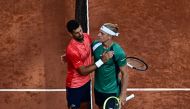Serbia's Novak Djokovic greets Spain's Alejandro Davidovich Fokina after winning their men's singles match on day six of the Roland-Garros Open tennis tournament at the Court Philippe-Chatrier in Paris on June 2, 2023. (Photo by JULIEN DE ROSA / AFP)