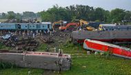 Policemen inspect the wrecked carriages of a three-train collision near Balasore, in India's eastern state of Odisha, on June 4, 2023. (Photo by Dibyangshu Sarkar / AFP)