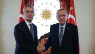 In this handout photograph taken and released by the Press Office of the Republic of Turkiye on June 4, 2023, Turkish President Recep Tayyip Erdogan (right) shakes hands with North Atlantic Treaty Organization (NATO) Secretary General Jens Stoltenberg at the Dolmabahce Office in Istanbul, Turkiye. (Photo by Handout / Press Office of the Presidency of Turkey / AFP)