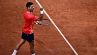 Serbia's Novak Djokovic celebrates his victory over Russia's Karen Khachanov during their men's singles quarter final match on day ten of the Roland-Garros Open tennis tournament at the Court Philippe-Chatrier in Paris on June 6, 2023. (Photo by JULIEN DE ROSA / AFP)