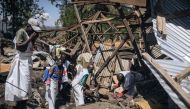Local Red Cross volunteers attempt to extract a corpse from the rubble of a house destroyed by a landslide in the village of Bushushu in Kalehe Territory, South Kivu Province, eastern Democratic Republic of Congo on June 9, 2023. (Photo by Alexis Huguet / AFP)
