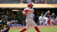 Kyle Schwarber #12 of the Philadelphia Phillies hits an rbi single scoring Cristian Pache #19 against the Oakland Athletics in the top of the 12th inning at RingCentral Coliseum on June 17, 2023 in Oakland, California. (Photo by Thearon W. Henderson / GETTY IMAGES NORTH AMERICA / Getty Images via AFP)