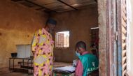 A voter registers to vote as polls open during Mali’s referendum in Bamako on June 18, 2023. 