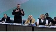 Russian opposition leader Alexei Navalny (2nd left) is seen on a screen during court hearings in the IK-6 penal colony at Melekhovo, about 250 kilometres (155 miles) east of Moscow, where he is jailed on June 19, 2023. (Photo by Natalia Kolesnikova / AFP)

