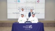 Minister of Environment and Climate Change H E Sheikh Dr. Faleh bin Nasser bin Ahmed bin Ali Al Thani (standing left) and President of Hamad Bin Khalifa University (HBKU) Dr. Ahmad Mujahid Omar Hasnah (standing right) witness the signing ceremony.
