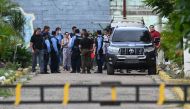 Prison staff, judges, and police officers remain inside the Women's Social Adaptation Center (CEFAS) prison after a fire following a brawl between inmates in Tamara, some 25 kilometers from Tegucigalpa, Honduras, on June 20, 2023.   (Photo by Orlando SIERRA / AFP)
