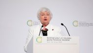 US Treasury Secretary Janet Yellen (C) speaks next to French President Emmanuel Macron (L) and World Bank President Ajay Banga (R) during the closing session of the New Global Financial Pact Summit, in Paris on June 23, 2023. (Photo by Lewis Joly / POOL / AFP)