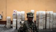 Soldier of the Sierra Leone Armed Forces walks past ballot boxes in Freetown on June 23, 2023. Photo by JOHN WESSELS / AFP