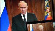 This photograph shows Russian President Vladimir Putin, seen on screens, making a statement in Moscow, on June 24, 2023 as Wagner fighters stage rebellion.  Photo by Pavel Bednyakov / SPUTNIK / AFP