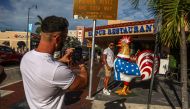 Tourists take photos with the distinctive rooster on 8th Street in Little Havana, Miami, Florida during on June 26, 2023. (Photo by Giorgio Viera / AFP)