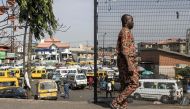 File photo: A man walks past a taxi stop in Lagos on February 28, 2023. (Photo by JOHN WESSELS / AFP)

