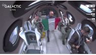 This still image from a Virgin Galactic video shows Galactic 01 mission crew members from the Italian Air Force display the Italian flag as they reach space during the first commercial flight from Spaceport City in New Mexico on June 29, 2023. (Photo by Jose Romero / Virgin Galactic / AFP)