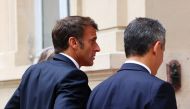 French President Emmanuel Macron (L) and French Interior and Overseas Minister Gerald Darmanin arrive to attend a intermninisterial crisis unit (Cellule interministerielle de crise - CIC) meeting after riots erupted for the third night in a row across the country following the death of Nahel, a 17-year-old teenager killed during a traffic stop in Nanterre by a French police officer, at the emergency crisis center of the Interior Ministry in Paris, France, June 30, 2023. (Photo by YVES HERMAN / POOL / AFP)
