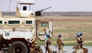 (FILES) Senegalese soldiers the UN peacekeeping mission in Mali MINUSMA (United Nations Multidimensional Integrated Stabilisation Mission in Mali) dismount an armoured personnel carrier, patrolling in the streets of Gao, on July 24, 2019. (Photo by Souleymane Ag Anara / AFP)
