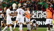 Qatar's players celebrate their victory following the Concacaf 2023 Gold Cup Group B football match between Mexico and Qatar at Levi's Stadium, in Santa Clara, California, on July 2, 2023. (Photo by Patrick T. Fallon / AFP)
