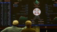 Stockbrokers monitor the latest share prices at the Pakistan Stock Exchange (PSE) in Karachi on July 3, 2023. (Photo by Asif Hassan / AFP)