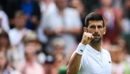 Serbia's Novak Djokovic celebrates after winning against Argentina's Pedro Cachin during their men's singles tennis match on the first day of the 2023 Wimbledon Championships at The All England Tennis Club in Wimbledon, southwest London, on July 3, 2023. (Photo by Daniel LEAL / AFP)