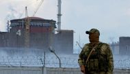 File Photo: A serviceman with a Russian flag on his uniform stands guard near the Zaporizhzhia Nuclear Power Plant in the Zaporizhzhia region, Ukraine, August 4, 2022. (REUTERS/Alexander Ermochenko)
