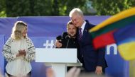 Ukrainian President Volodymyr Zelensky (centre) gets a hug by Lithuania's President Gitanas Nauseda after addressing the crowd at Lukiskiu Square in Vilnius on July 11, 2023, during a NATO Summit. (Photo by Petras Malukas / AFP)

