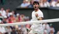 Spain's Carlos Alcaraz reacts as he plays against Italy's Matteo Berrettini during their men's singles tennis match on the eighth day of the 2023 Wimbledon Championships at The All England Tennis Club in Wimbledon, southwest London, on July 10, 2023. Photo by Adrian DENNIS / AFP