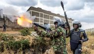 A Kenya Police Officer shoots a tear gas canister to disperse some protesters as they gather to demonstrate in Nairobi, Kenya on July 12, 2023. (Photo by Luis Tato / AFP)
