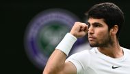 Spain's Carlos Alcaraz reacts as he plays against Russia's Daniil Medvedev during their men's singles semi-finals tennis match on the twelfth day of the 2023 Wimbledon Championships at The All England Lawn Tennis Club in Wimbledon, southwest London, on July 14, 2023. Photo by SEBASTIEN BOZON / AFP