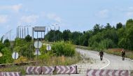 Ukrainian border guards patrol on the closed check point of Slavutych on the Ukrainian-Belarusian border in the Chernihiv region on July 14, 2023, amid the Russian invasion of Ukraine. (Photo by Sergei SUPINSKY / AFP)
