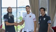 Dutch striker Naoufal Bannis (centre) with Al Markhiya officials after signing the contract.
