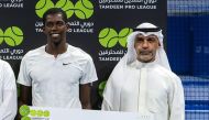 Qatar's Mubarak Shannan (left) holds the winner's prize after the Tamdeen Pro League final in Kuwait.