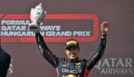 Third placed Red Bull Racing's Mexican driver Sergio Perez lifts his trophy on the podium after the Formula One Hungarian Grand Prix at the Hungaroring race track in Mogyorod near Budapest on July 23, 2023. Photo by ATTILA KISBENEDEK / AFP