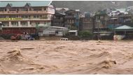 In this handout photo on July 26, 2023, vehicles are seen submerged as water rises along Chico River in Bontoc, Mountain Province. (Photo by Handout / Mountain Province Disaster Risk Reduction Management Office / AFP) 