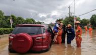 Rescuers evacuate residents in a flooded area after Typhoon Doksuri landfall in Quanzhou, in China's eastern Fujian province on July 28, 2023. (Photo by CNS / AFP) 