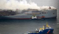 This handout photograph taken on July 28, 2023 from the Coast Guard plane and released on July 29, 2023 by the Dutch coastguards, shows a Multrasalvor 4 rescue vessel sailing next to a fire aboard the Panamanian-registered car carrier ship Fremantle Highway, after a fire broke out on the Fremantle Highway late on July 25, 2023, killing one crew member, and prompting a massive effort to extinguish the flames. Photo by Handout / Netherlands Coastguards / AFP
