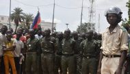 A Nigerien policeman stands as Nigerien cadets paradeas supporters rally in support of Niger's junta in Niamey on July 30, 2023. (Photo by AFP)
