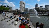 Tourists visit the Merlion Statue at Marina Bay in Singapore on July 31, 2023. (Photo by Mohd RASFAN / AFP)