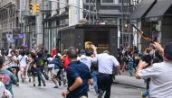 Plates are thrown near Chelsea as members of the NYPD respond to the disruptions caused by large crowds during a 