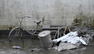 A tricycle covered with mud is seen by a villager house in the aftermath of flooding from heavy rains in Zhuozhou city, in northern China Hebei province on August 9, 2023. Photo by Jade Gao / AFP