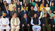 Pakistan's Prime Minister Shehbaz Sharif (3L in front row) poses for a photograph with parliamentarians after current last session of National Assembly outside the parliament house building in Islamabad on August 9, 2023. (Photo by Aamir QURESHI / AFP)
