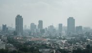 In this picture taken on August 9, 2023, buildings are seen in the haze caused by the air pollution in Jakarta. (Photo by Yasuyoshi Chiba / AFP)