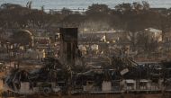 Burned houses and buildings are pictured in the aftermath of a wildfire, is seen in Lahaina, western Maui, Hawaii on August 12, 2023. Photos by Yuki IWAMURA / AFP