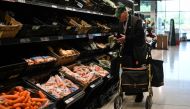 A customer looks at some vegetables at the Asda supermarket, in Amesbury, England, on August 15, 2023. Photo by JUSTIN TALLIS / AFP