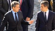 (Files) Former French President Nicolas Sarkozy (L) and French Minister of Public Action and Accounts Gerald Darmanin attend the national tribute to French-Armenian singer-songwriter Charles Aznavour at the Invalides in Paris on October 5, 2018. (Photo by Ludovic Marin / AFP)
 