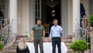 Ukrainian President Volodymyr Zelensky and Swedish Prime Minister Ulf Kristersson take a walk in the garden of the minister's countryside retreat in Harpsund, south-west of Stockholm, Sweden on August 19, 2023. (Photo by Jonathan NACKSTRAND / AFP)
