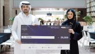 Mohammad Fadhel Annan and Lujain Al Mansoori with a cheque of QR25,000.